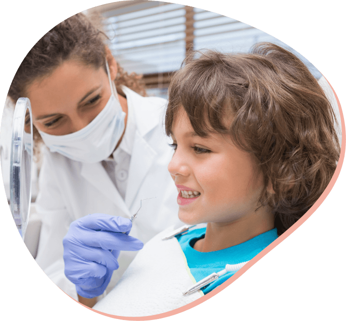 pediatric-dentist-showing-little-boy-his-teeth-mirror.png pediatric-dentist-showing-little-boy-his-teeth-mirror